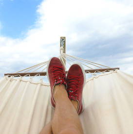 niksen-art-of-doing-nothing-lounging-in-white-hammock